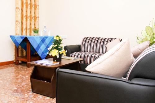 a living room with a couch and a table at Hotel Nilketha Yala Tissamaharama in Tissamaharama