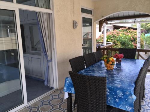 a table with a vase of fruit on a balcony at Studio Manguillier in Trou d'Eau Douce