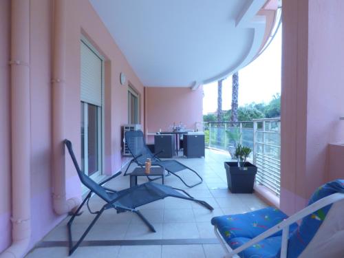 a balcony with two chairs and a table at Mer, plages, piscine, paysages ydilliques:LE REVE! in Théoule-sur-Mer