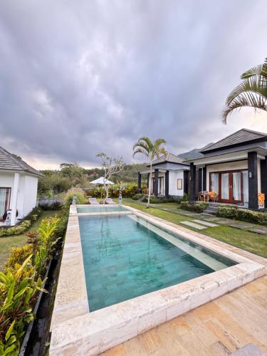 a swimming pool in the backyard of a house at Bali Astetic Villa and Hot Spring in Kintamani