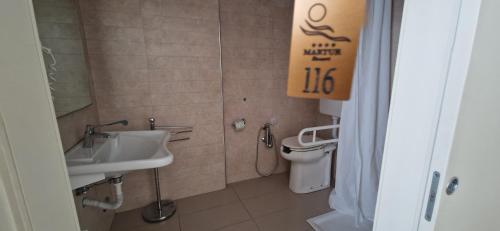 a bathroom with a sink and a toilet at Martur Resort in Termoli