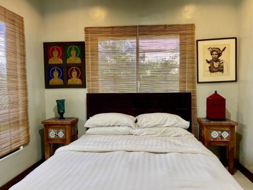 a bedroom with a large white bed with two night stands at 3 BedRoom Penthouse in Boracay Station 1 in Boracay