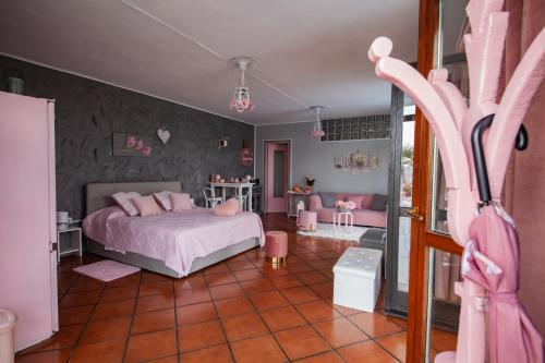 a bedroom with a pink bed and pink furniture at Oasirelax -camera con vista a un passo da torino in Pavarolo