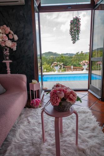 a living room with a table with flowers on it at Oasirelax -camera con vista a un passo da torino in Pavarolo