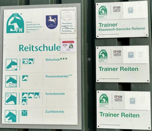 a bunch of signs on a gas station at Ferienwohnung und Pension Knabbe in Loxstedt