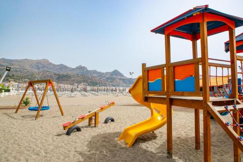 a group of playground equipment on a beach at Hotel Caesar Palace in Giardini Naxos