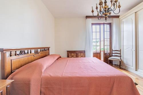 a bedroom with a large bed with a red blanket at GOLDEN LUXE - Grand Villa with Exlusive Garden in Camaiore