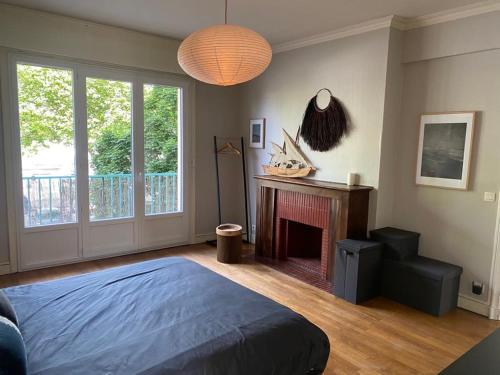 a bedroom with a bed and a fire place at Hypercentral flat for 6 in Lorient in Lorient