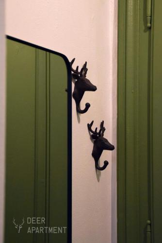 a mirror with a demon on the side of a wall at Deer Apartment - exclusive apartment Jihlava in Jihlava