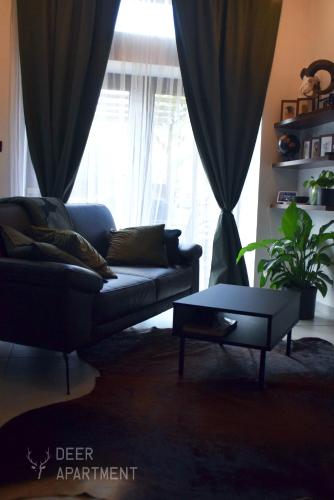 a living room with a couch and a table at Deer Apartment - exclusive apartment Jihlava in Jihlava