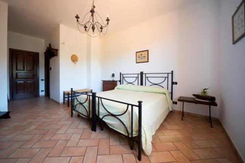 a bedroom with a bed and a chandelier at Agriturismo Casale Piè d'Eco in Calvanico