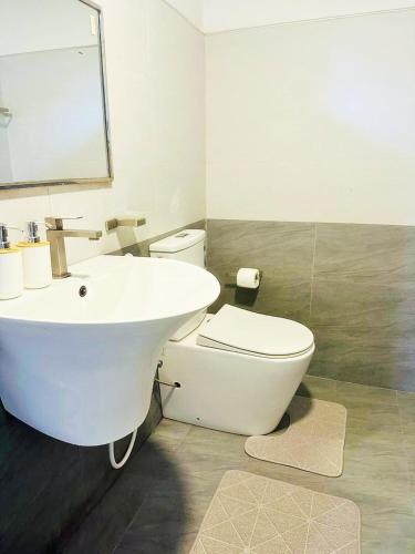 a bathroom with a white sink and a toilet at Villa 121 in Kandy