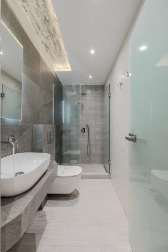 a bathroom with a sink and a toilet and a shower at Metsikas Residence in Limenas