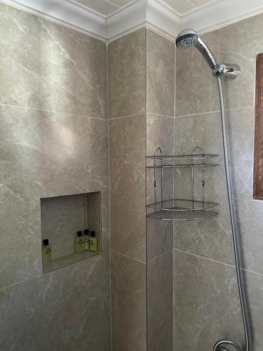a bathroom with a shower with a shower head at The White House Kalkan in Kalkan