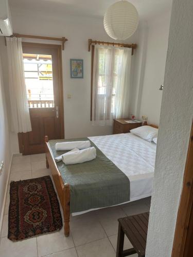 a bedroom with a bed with two towels on it at The White House Kalkan in Kalkan