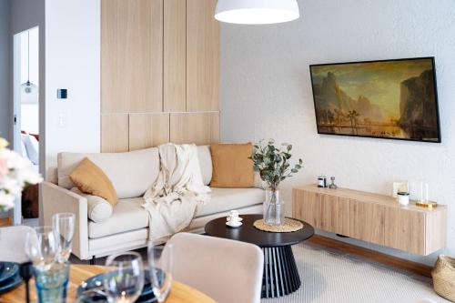 a living room with a couch and a table at Sol Marina Resort Wyspa Sobieszewska I - LoftAffair Collection in Wiślinka
