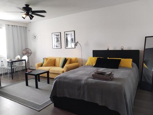 a bedroom with a large bed and a couch at Viihtyisä yksiö Korialla in Kouvola