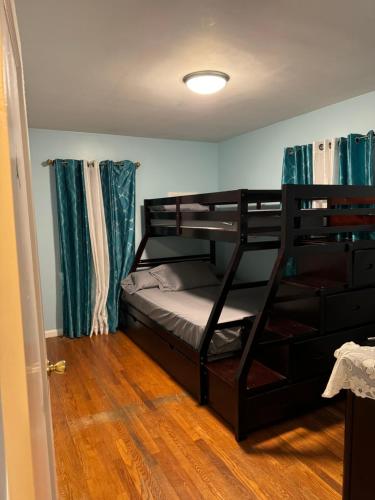a bedroom with two bunk beds in a room at La Casa Bonita Near NYC in Yonkers