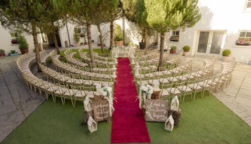 an outdoor wedding ceremony with chairs and a red carpet at Tulfarris Hotel and Golf Resort in Blessington
