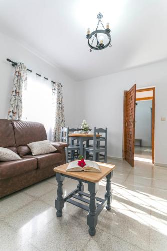 a living room with a couch and a table at Embrujo Andaluz Complejo Rural Órgiva in Órgiva