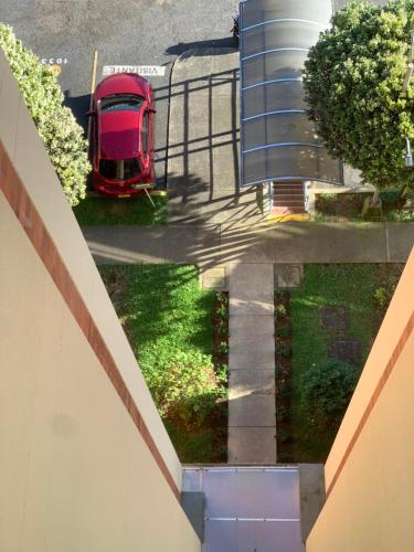 an overhead view of a red car parked on a street at Apartamento amoblado nuevo in Pereira