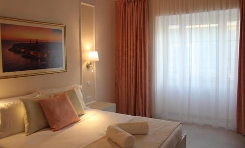 a bedroom with a bed with a large window at North Lodge by PetitChic in Mellieħa