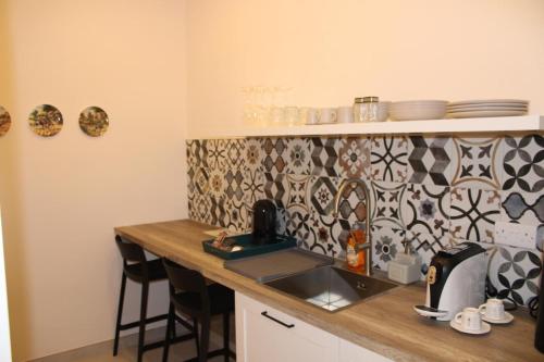 a kitchen with a sink and a counter top at North Lodge by PetitChic in Mellieħa