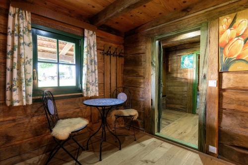 a room with a table and chairs in a cabin at Kozline Kordun in Veljun