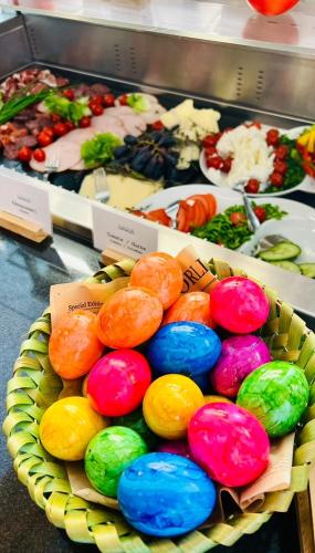 a plate of colorful donuts sitting on a table at Konferenzhotel Ysenburger Hof in Langenselbold