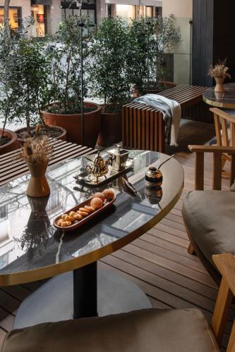 a table with a tray of food on a balcony at Casa Lucia Member of Melia Collection in Buenos Aires