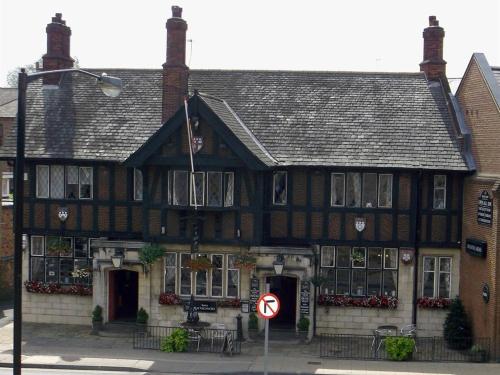 an old black and white building with a no parking sign at Masons Arms in York