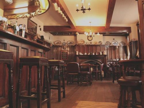 a dining room with tables and chairs and a fireplace at Masons Arms in York