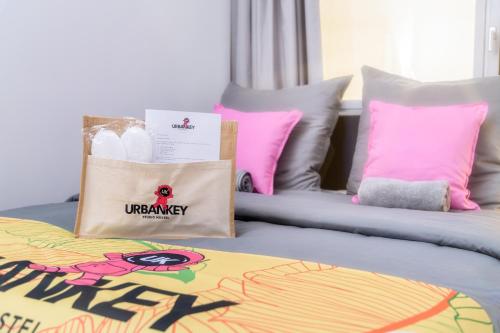 a bed with pillows and a bag on it at UrbanKey Studios - Vienna Neubau in Vienna