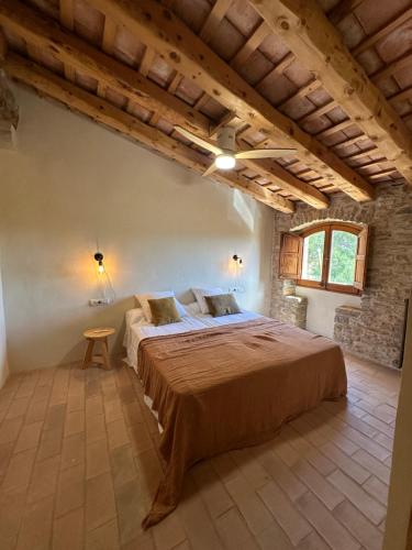 a bedroom with a large bed in a building at Can Casellas in Palau Sator