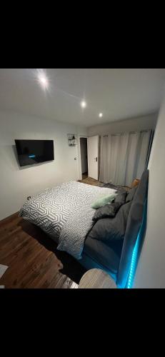 une chambre avec un lit et une télévision dans l'établissement MK Villa moderne / Jardin exotique, à Villecresnes