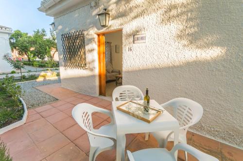 a white table and chairs on a patio at Embrujo Andaluz Complejo Rural Órgiva in Órgiva