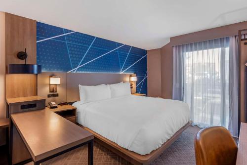 a hotel room with a bed and a desk at Comfort Inn & Suites Irvine Spectrum in Lake Forest