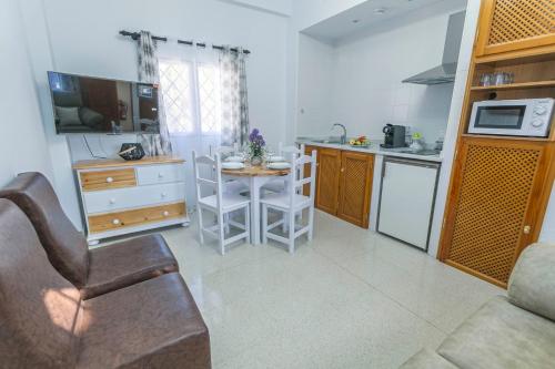 a kitchen with a small table and a kitchen with a counter at Embrujo Andaluz Complejo Rural Órgiva in Órgiva