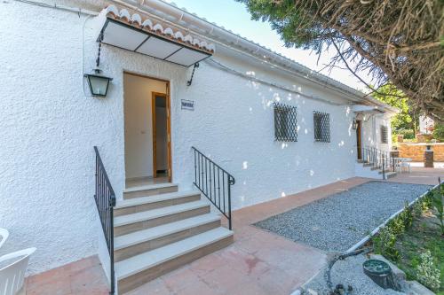 a white house with stairs and a door at Embrujo Andaluz Complejo Rural Órgiva in Órgiva