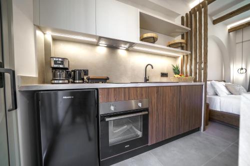 a kitchen with a sink and a stove at Αnasa by the sea in Agia Pelagia