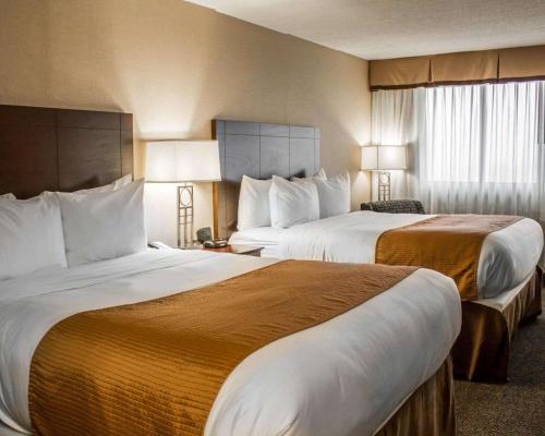 a hotel room with two beds and two lamps at Comfort Inn & Suites Wadsworth in Wadsworth