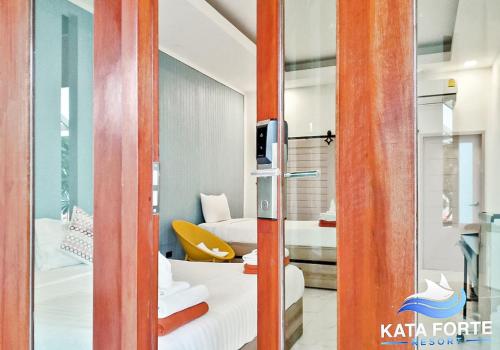 a room with a view of a bedroom at Kata Forte Resort in Kata Beach