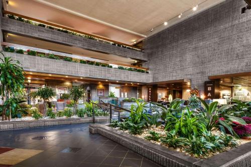 a lobby of a hotel with plants at Radisson Hotel Corning in Corning