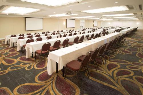 a large room with tables and chairs in it at Radisson Hotel Corning in Corning