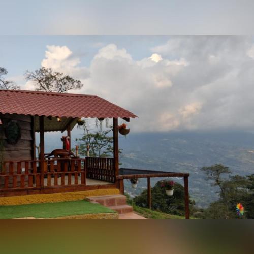 a house with a porch and stairs on a hill at Villa Emboscada Glamping in Silvania