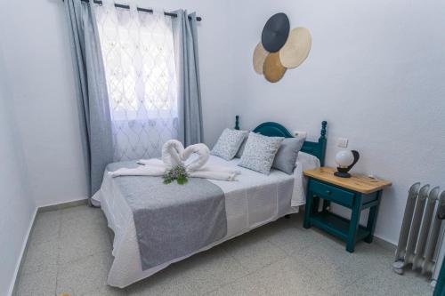 a small bedroom with a bed and a window at Embrujo Andaluz Complejo Rural Órgiva in Órgiva