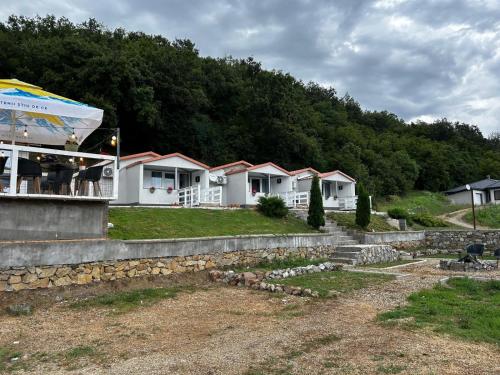 a row of cottages with a tent in front at Route 57 Sichevița in Sicheviţa