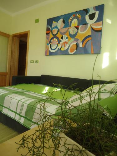 a bedroom with two beds and a painting on the wall at Apartment Šavli in Kobarid