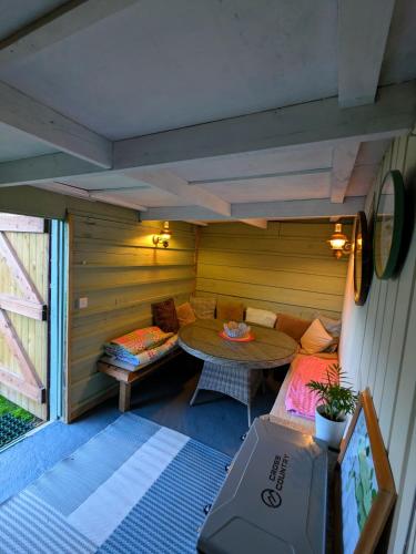 a small room with a table and a couch at Highview Hideaway in Upchurch
