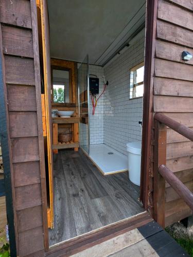 a bathroom with a shower and a toilet in a house at Highview Hideaway in Upchurch
